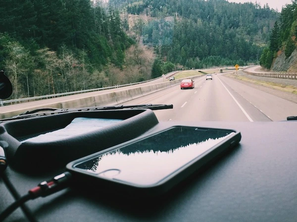 iPhone on car dashboard.