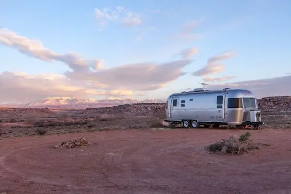 Is towing a travel trailer difficult? Not for this Airstream Camper at their campsite.
